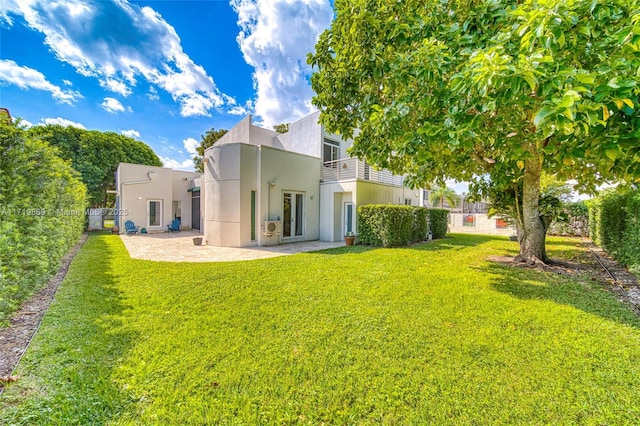 back of property featuring a yard and a patio area