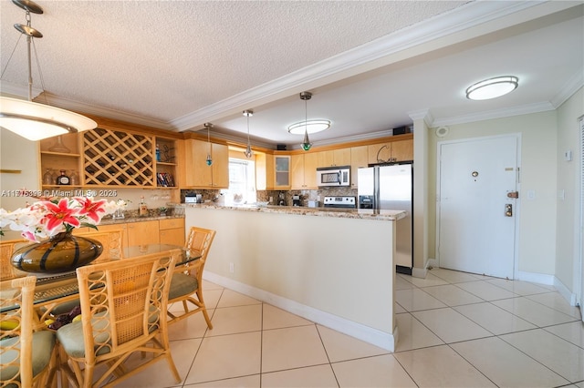 kitchen with appliances with stainless steel finishes, tasteful backsplash, ornamental molding, hanging light fixtures, and light tile patterned flooring