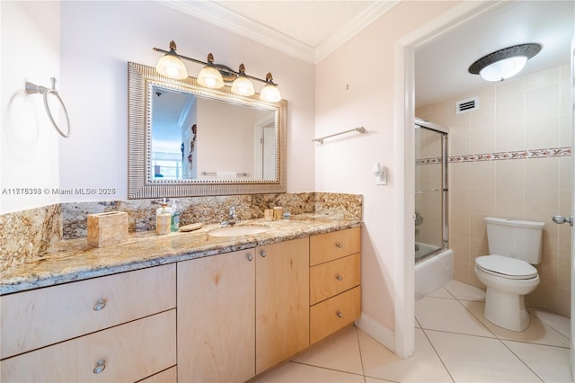 full bathroom with tile patterned flooring, toilet, shower / bath combination with glass door, vanity, and ornamental molding