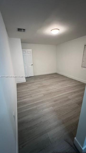 unfurnished room with wood-type flooring