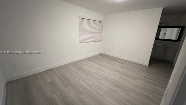 empty room with light hardwood / wood-style flooring