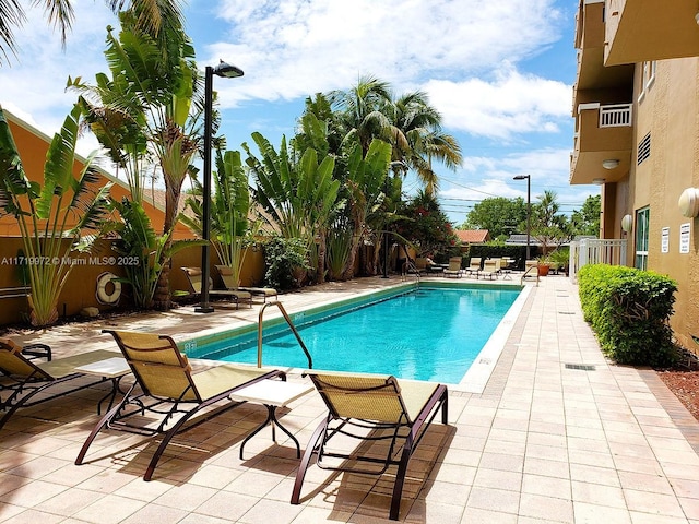 view of swimming pool featuring a patio area