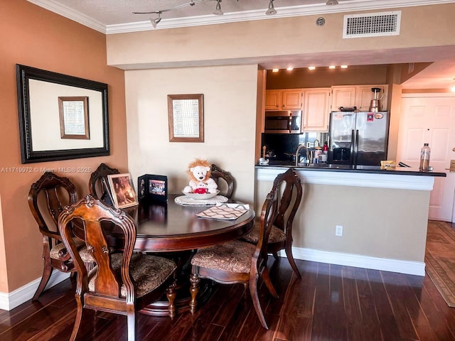 dining room with dark hardwood / wood-style floors and ornamental molding