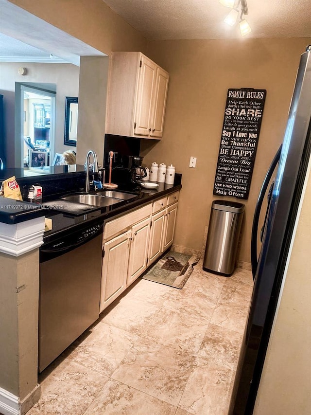 kitchen featuring sink, stainless steel appliances, and a textured ceiling