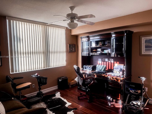 office space featuring ceiling fan, dark hardwood / wood-style flooring, and a textured ceiling