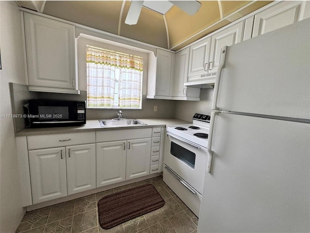 kitchen featuring dark tile patterned flooring, white cabinetry, white appliances, and sink