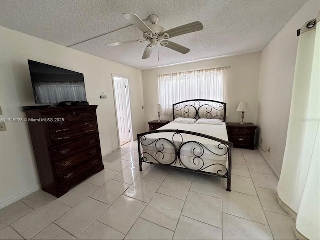 tiled bedroom featuring a textured ceiling and ceiling fan