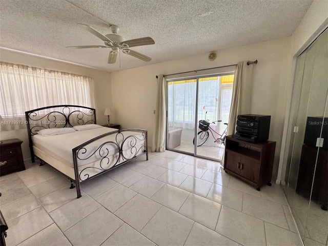 tiled bedroom with a textured ceiling, access to outside, and ceiling fan