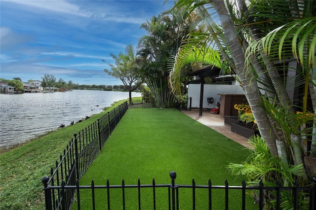 view of yard with a patio area and a water view