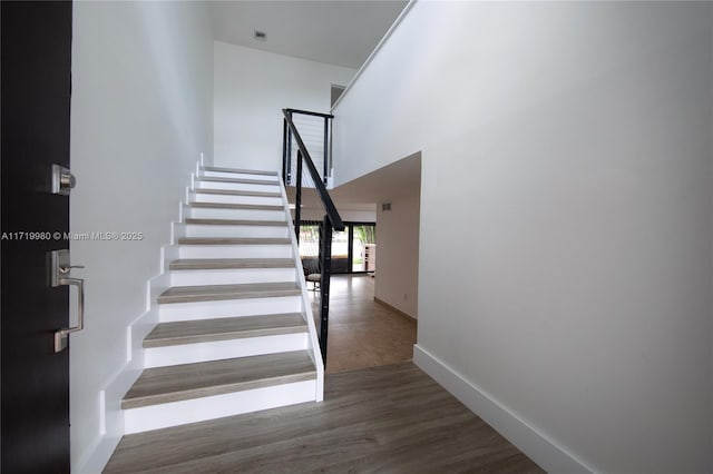 stairs featuring wood-type flooring