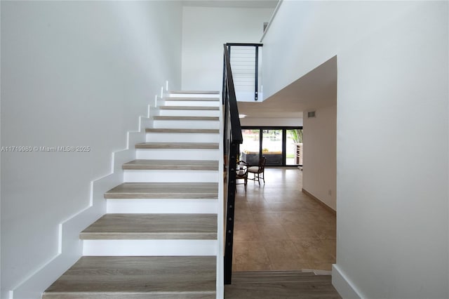 stairway with a towering ceiling