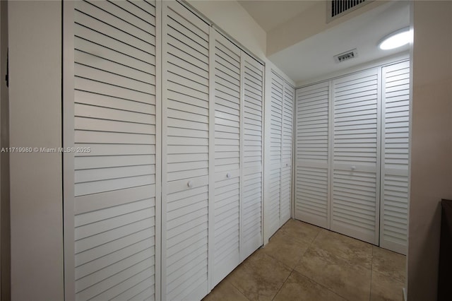 corridor featuring light tile patterned floors