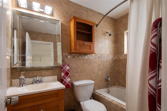 full bathroom with shower / bath combo, vanity, toilet, and tile walls