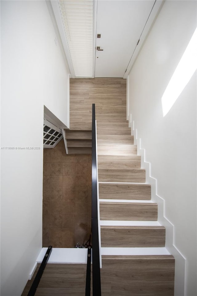 stairs featuring hardwood / wood-style floors