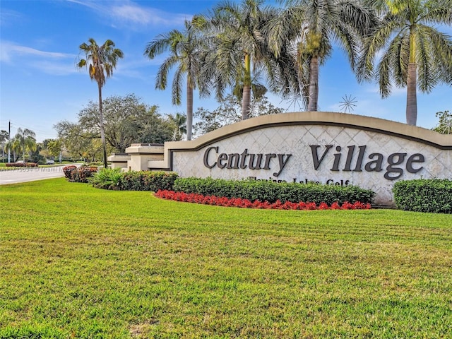 community sign featuring a lawn