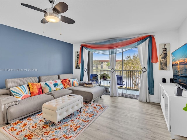 living room featuring ceiling fan and wood finished floors