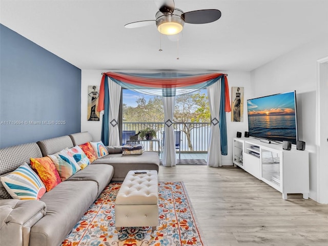 living room with wood finished floors and a ceiling fan