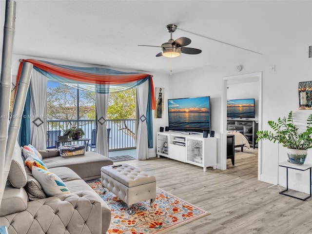 living area with light wood-type flooring and a ceiling fan