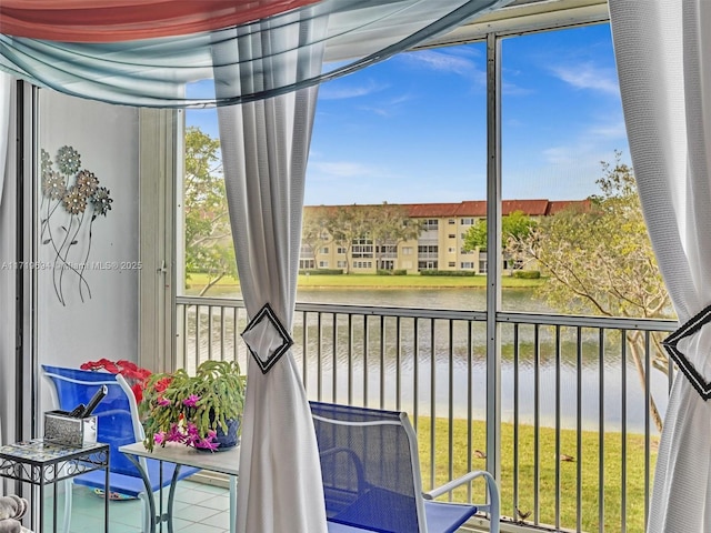 sunroom / solarium with a water view