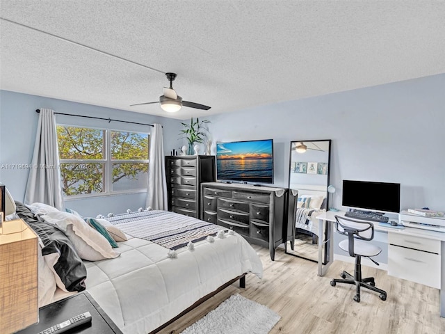 bedroom with a textured ceiling, a ceiling fan, and wood finished floors