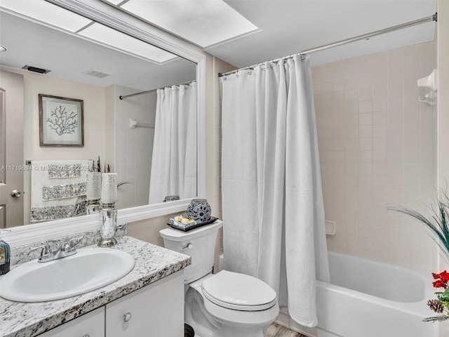 full bathroom with toilet, shower / tub combo, vanity, and visible vents