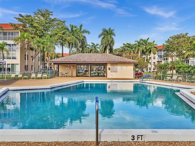 community pool featuring a patio area and fence