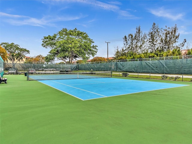 view of tennis court featuring fence