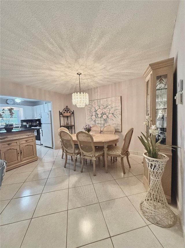 tiled dining area featuring an inviting chandelier