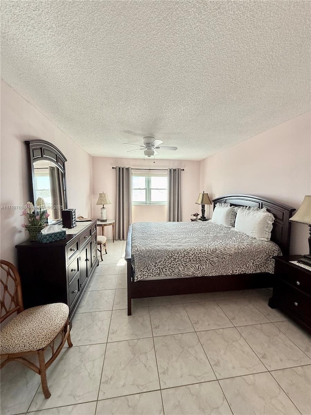 bedroom with a textured ceiling and ceiling fan