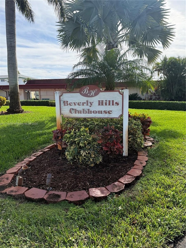 community / neighborhood sign with a lawn