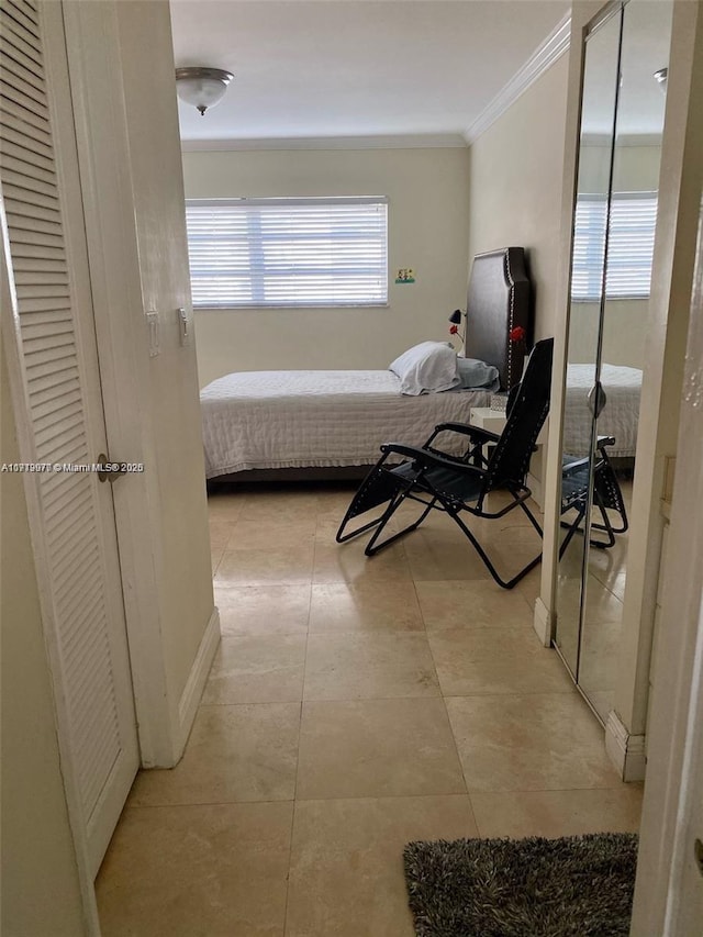 bedroom featuring light tile patterned flooring and crown molding