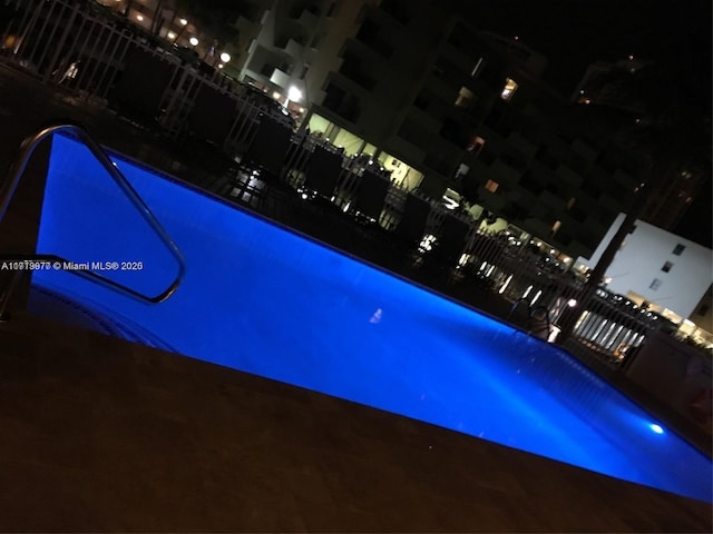 view of pool at night