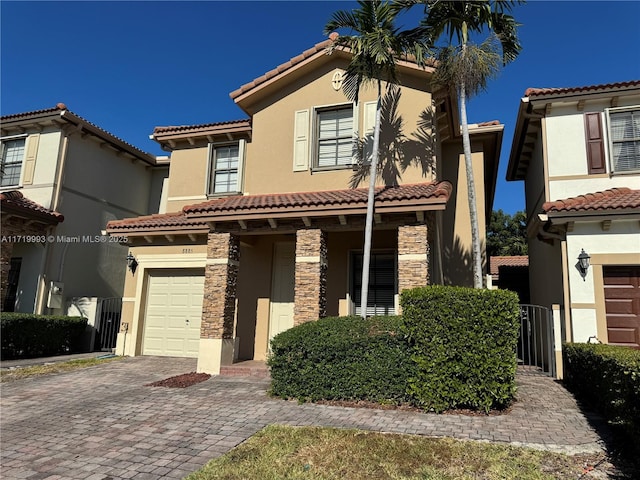 mediterranean / spanish-style house with a garage