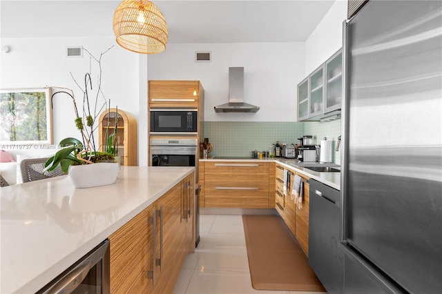 kitchen with black appliances, wall chimney range hood, wine cooler, decorative backsplash, and light tile patterned floors