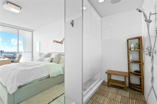 bathroom with an enclosed shower and expansive windows