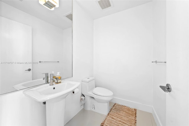 bathroom featuring sink, tile patterned flooring, and toilet