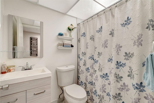 bathroom featuring vanity, toilet, and walk in shower