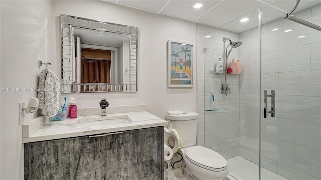 bathroom with vanity, toilet, and a shower with shower door