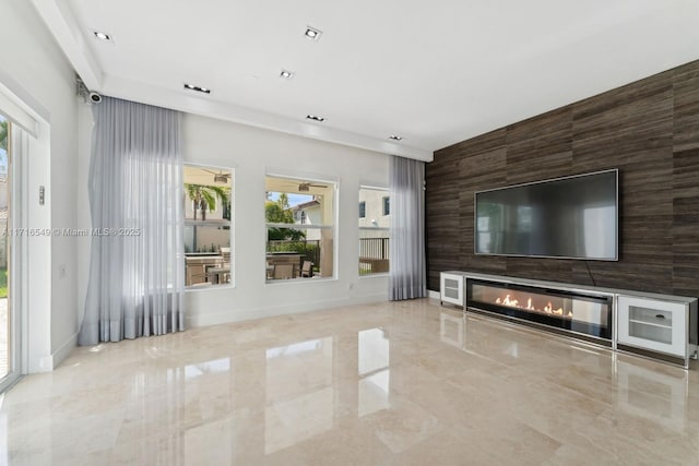 unfurnished living room featuring tile walls