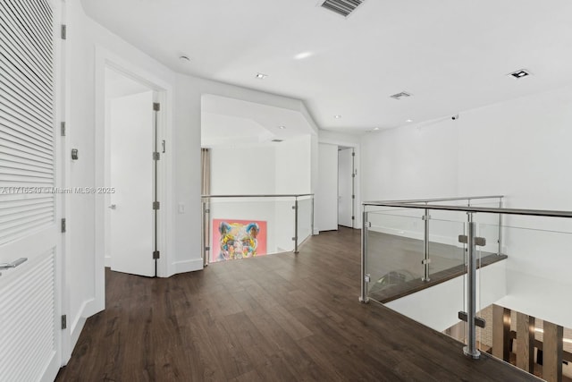 hallway with dark hardwood / wood-style flooring