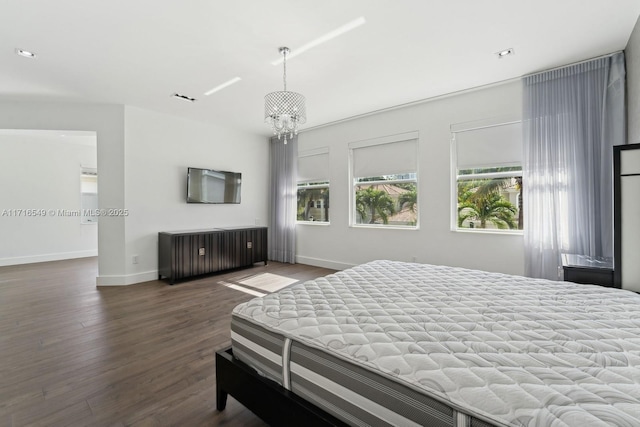 bedroom with a chandelier and dark hardwood / wood-style floors