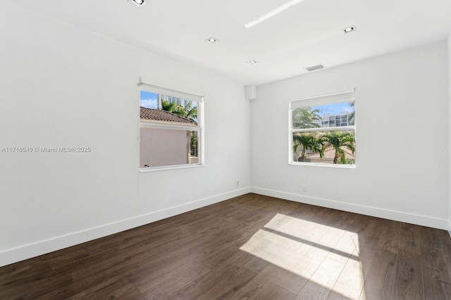 spare room featuring dark hardwood / wood-style flooring