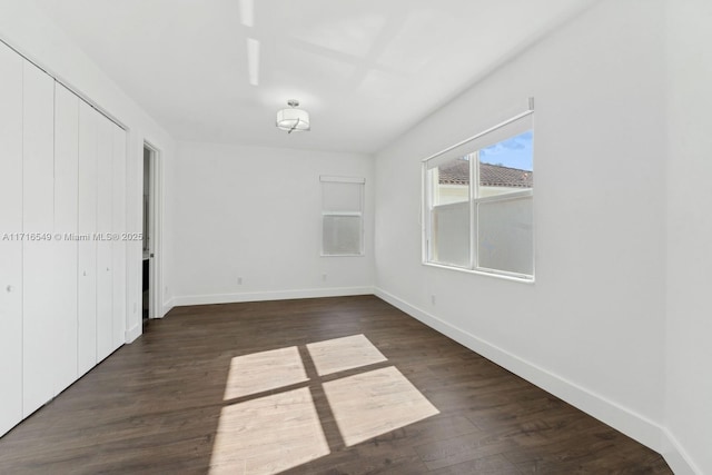 unfurnished bedroom with dark hardwood / wood-style flooring