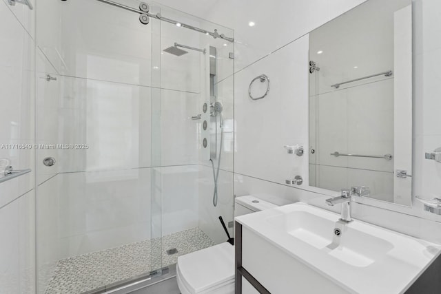 bathroom featuring toilet, an enclosed shower, and vanity