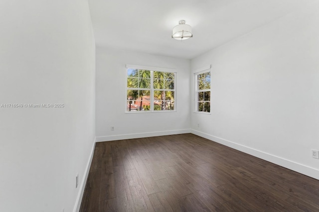 empty room with dark hardwood / wood-style floors