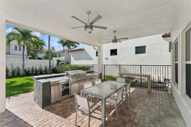 view of patio / terrace featuring ceiling fan, exterior kitchen, and grilling area