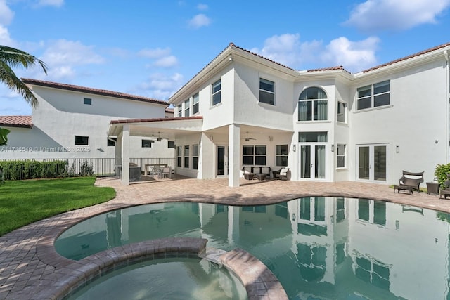 back of house with a patio area, ceiling fan, french doors, and a lawn