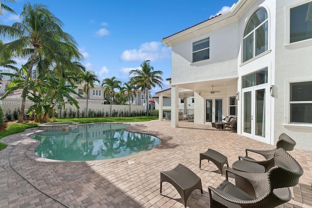 view of pool featuring a patio area, ceiling fan, french doors, and an in ground hot tub