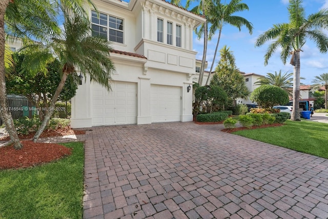 view of front facade featuring a garage and a front lawn