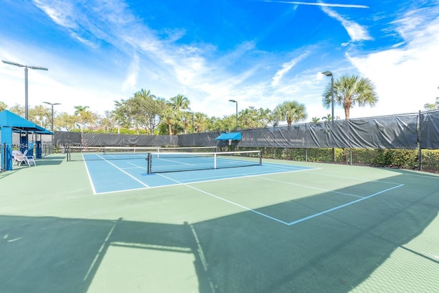 view of tennis court featuring basketball court